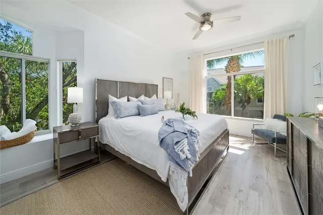 a bedroom with a bed couch and a large window