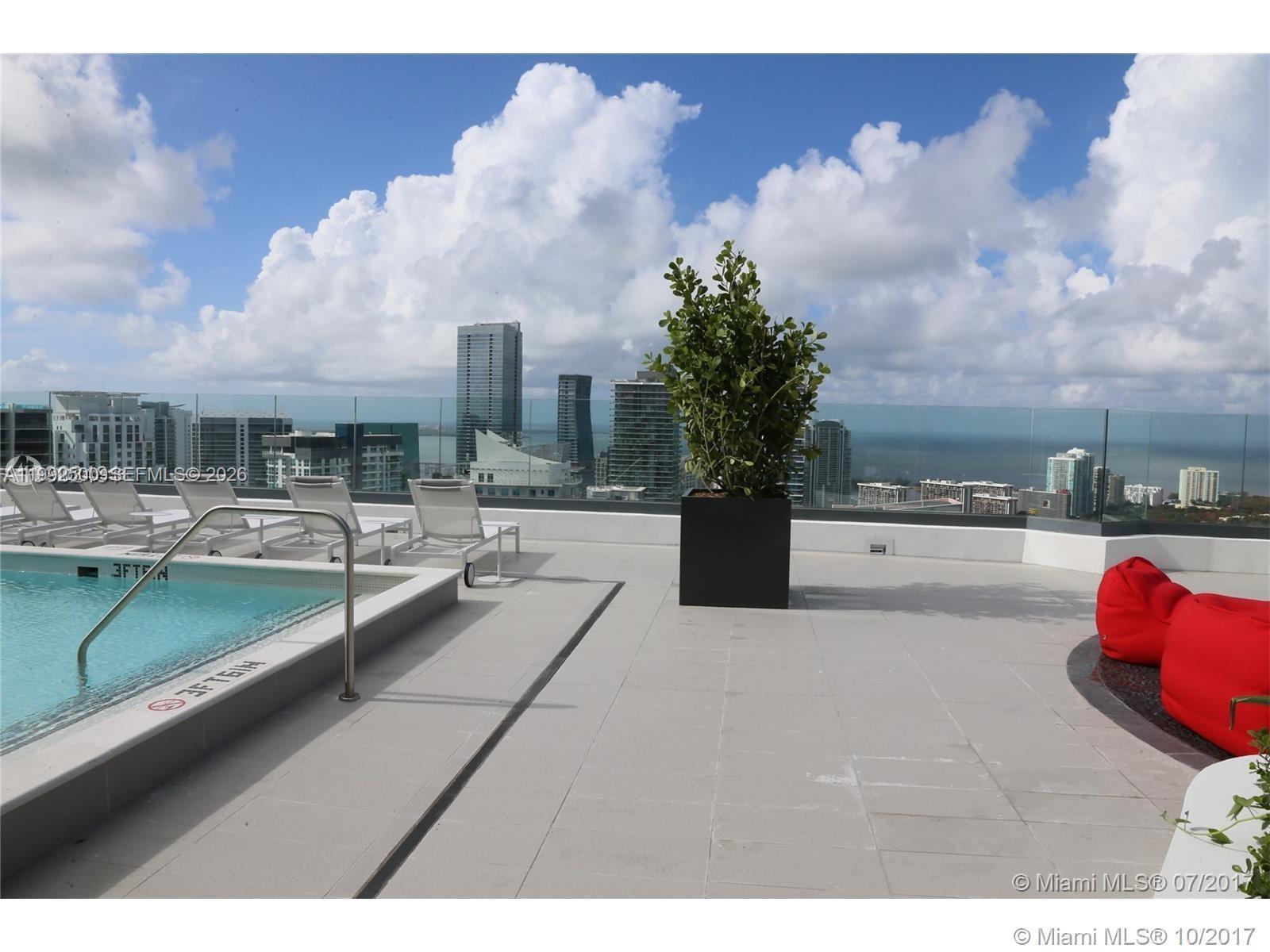 55 Southwest 9th Street, Unit 3709 Miami, FL 33130 - Photo 47 of 52 a view of swimming pool outdoor seating and living room