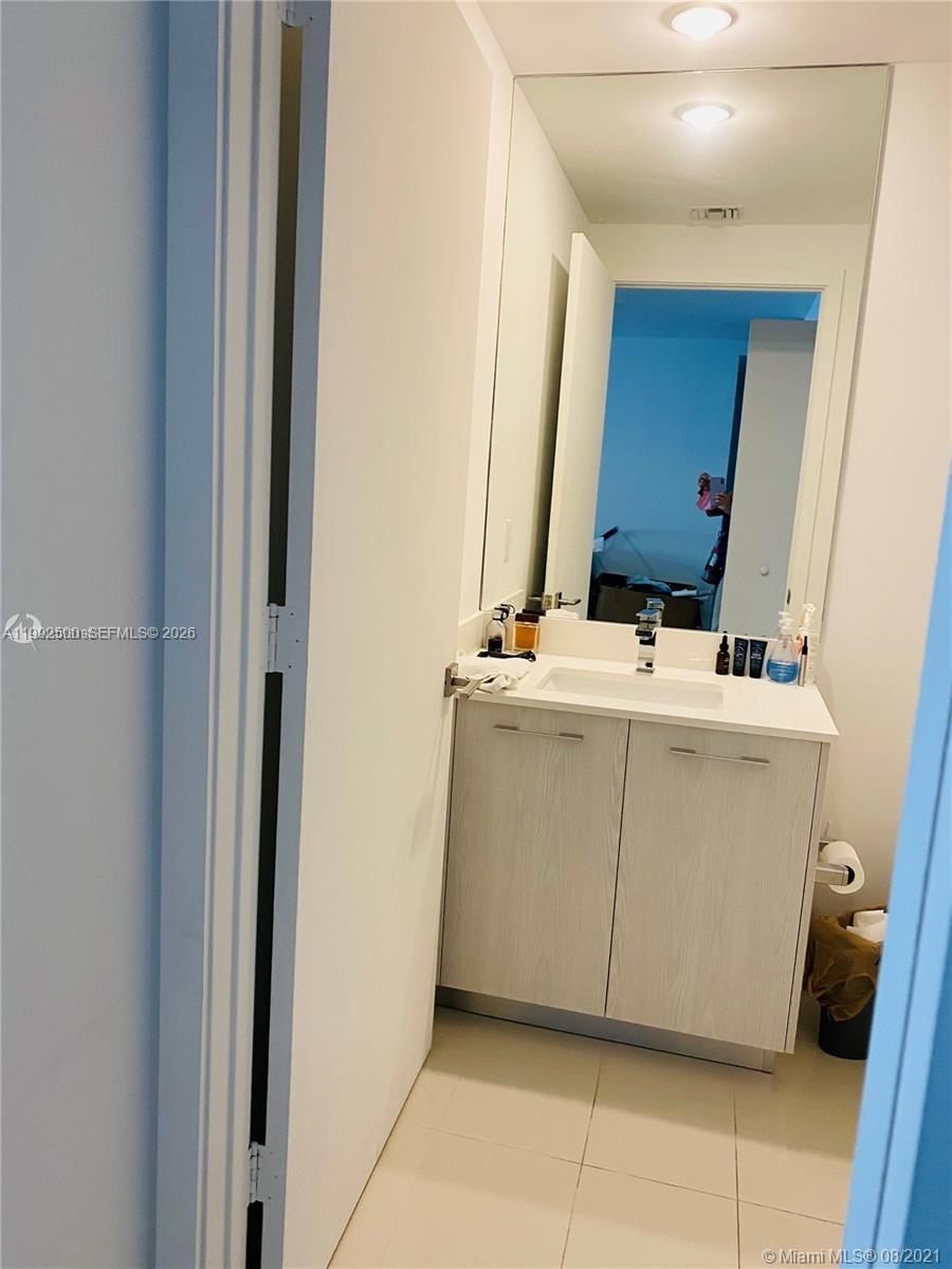 55 Southwest 9th Street, Unit 3709 Miami, FL 33130 - Photo 5 of 52 a utility room with a sink and a mirror