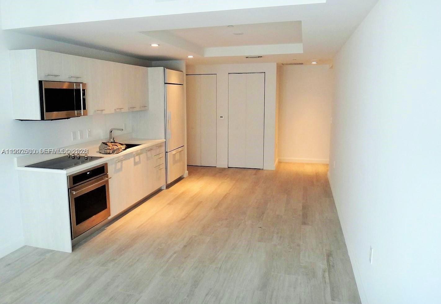 55 Southwest 9th Street, Unit 3709 Miami, FL 33130 - Photo 51 of 52 a view of a kitchen with stainless steel appliances wooden floor and chair