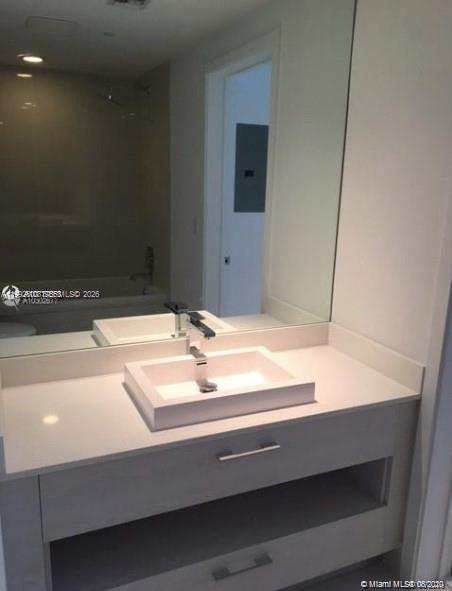 55 Southwest 9th Street, Unit 3709 Miami, FL 33130 - Photo 10 of 52 a bathroom with a sink and a mirror
