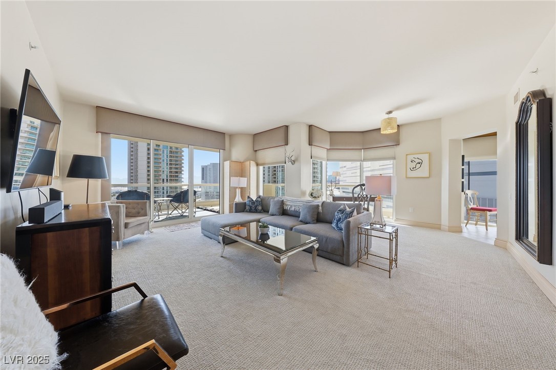 2747 Paradise Road, Unit 1205 Las Vegas, NV 89109 - Photo 11 of 32 Living room with light carpet and a city view