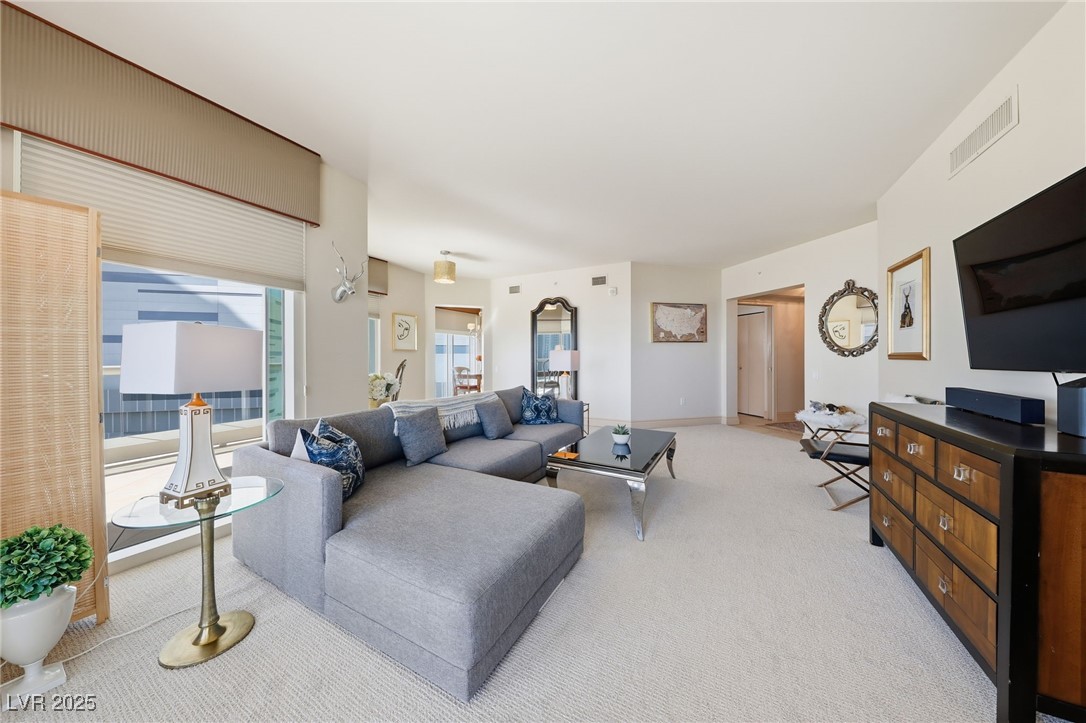 2747 Paradise Road, Unit 1205 Las Vegas, NV 89109 - Photo 12 of 32 Living room with light carpet and baseboards