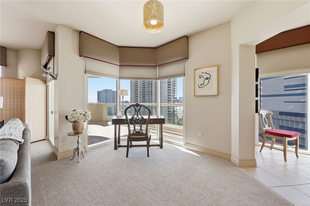 2747 Paradise Road, Unit 1205 Las Vegas, NV 89109 - Photo 13 of 32 Carpeted home office with a skyline view and tile patterned floors