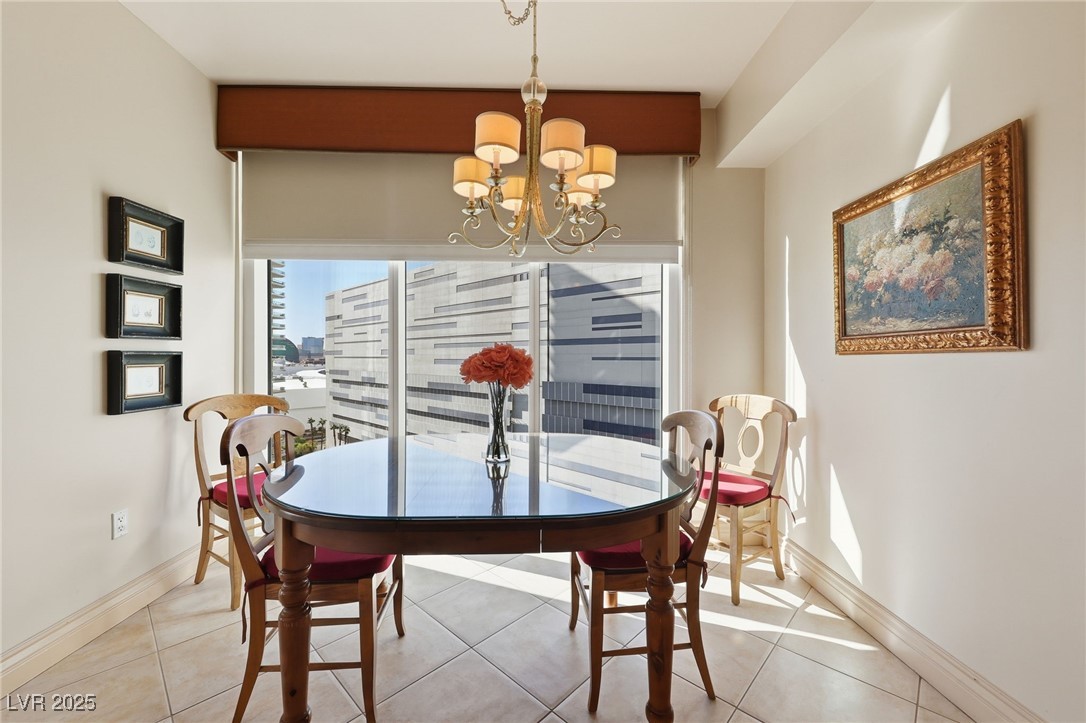 2747 Paradise Road, Unit 1205 Las Vegas, NV 89109 - Photo 14 of 32 Dining area with tile patterned flooring and a chandelier