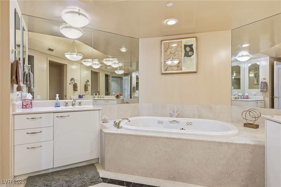 2747 Paradise Road, Unit 1205 Las Vegas, NV 89109 - Photo 6 of 32 Bathroom featuring a garden tub, vanity, light tile patterned floors, and recessed lighting