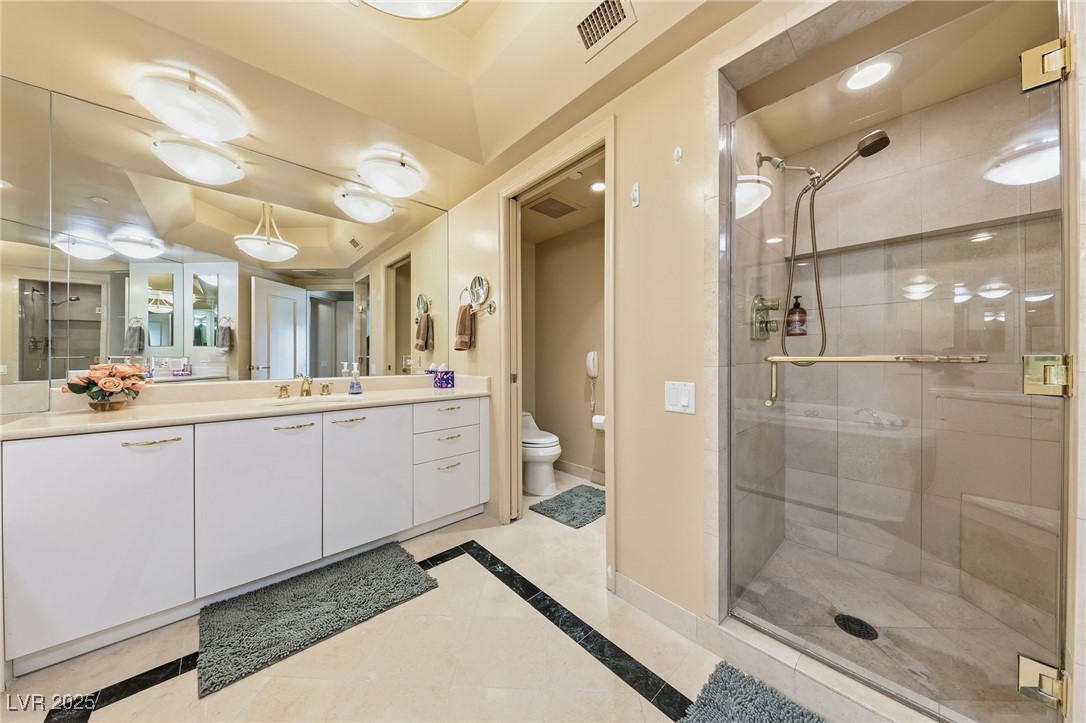2747 Paradise Road, Unit 1205 Las Vegas, NV 89109 - Photo 7 of 32 Full bath with vanity, a shower stall, inlaid floor details, and recessed lighting