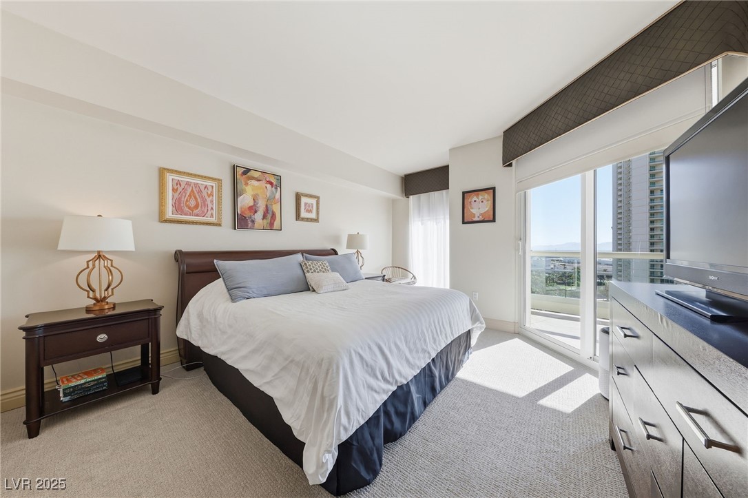 2747 Paradise Road, Unit 1205 Las Vegas, NV 89109 - Photo 8 of 32 Bedroom featuring access to exterior and light colored carpet