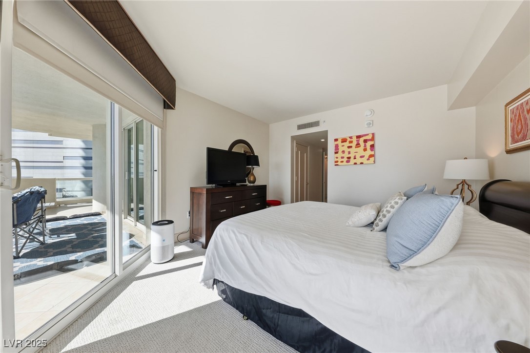 2747 Paradise Road, Unit 1205 Las Vegas, NV 89109 - Photo 9 of 32 Bedroom featuring access to outside and carpet flooring