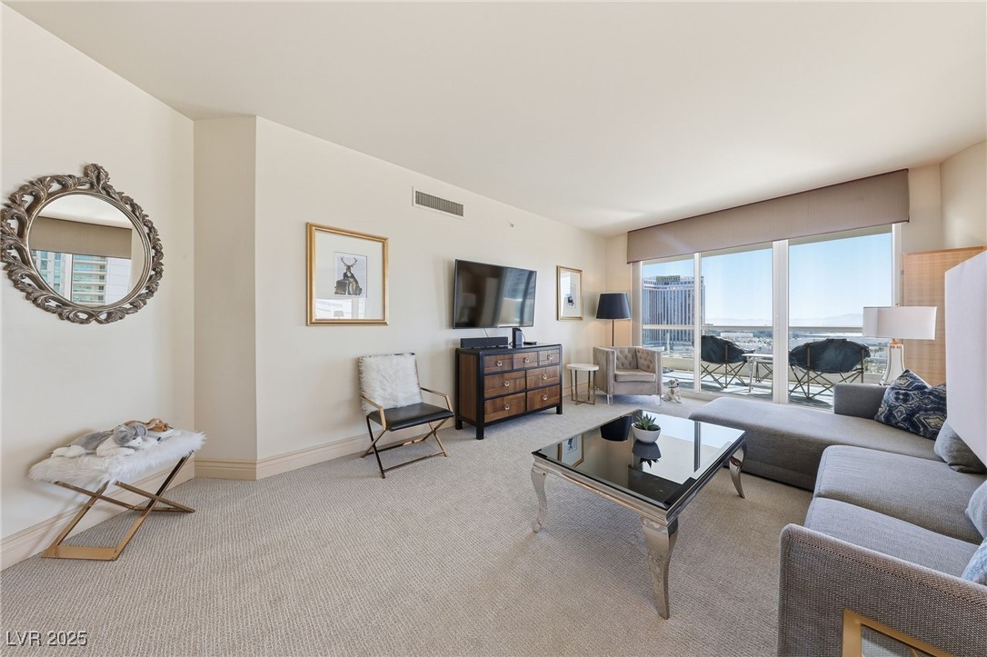 2747 Paradise Road, Unit 1205 Las Vegas, NV 89109 - Photo 10 of 32 Carpeted living room with baseboards