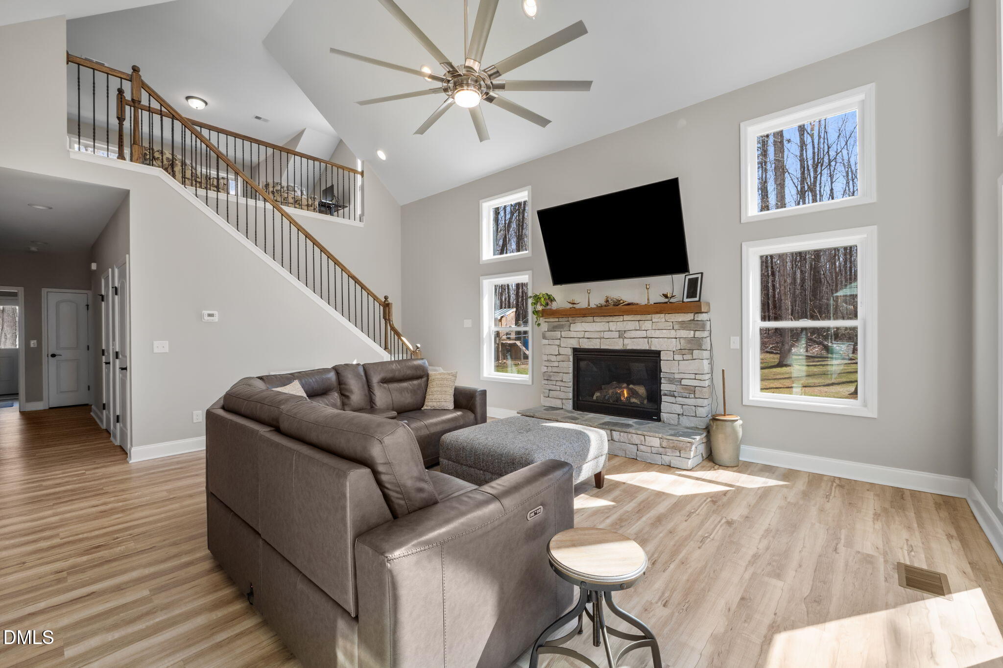 8514 Charlie Stovall Road Roxboro, NC 27574 - Photo 19 of 48 a living room with furniture a flat screen tv and a fireplace