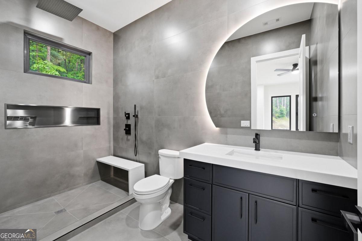 1563 Whitley Road Bethlehem, GA 30620 - Photo 31 of 44 a bathroom with a toilet sink and mirror