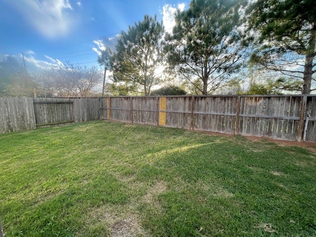 8115 Redbud Point Lane Houston, TX 77049 - Photo 14 of 14 a view of a backyard with a fence and trees