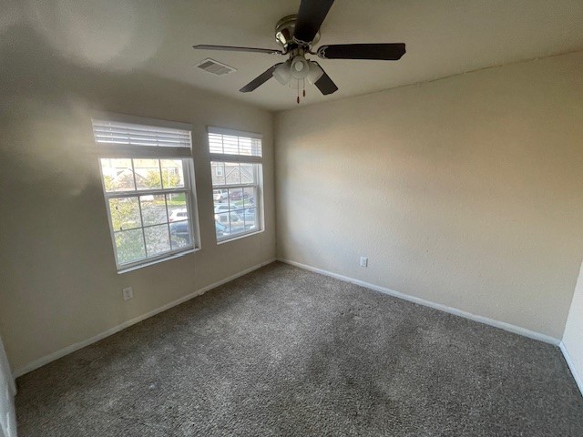 8115 Redbud Point Lane Houston, TX 77049 - Photo 9 of 14 an empty room with a window and a fan