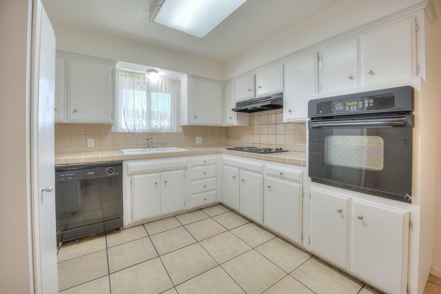 2811 North Winery Avenue Clovis, CA 93612 - Photo 11 of 25 a kitchen with cabinets appliances and a sink