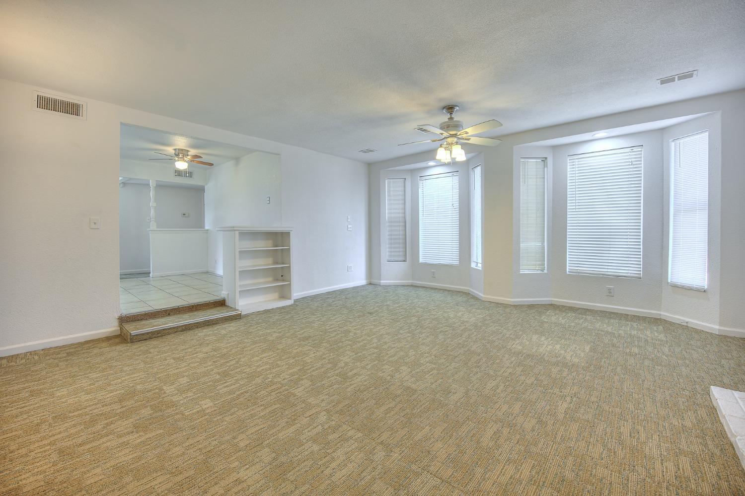 2811 North Winery Avenue Clovis, CA 93612 - Photo 15 of 25 a view of an empty room with chandelier fan and window