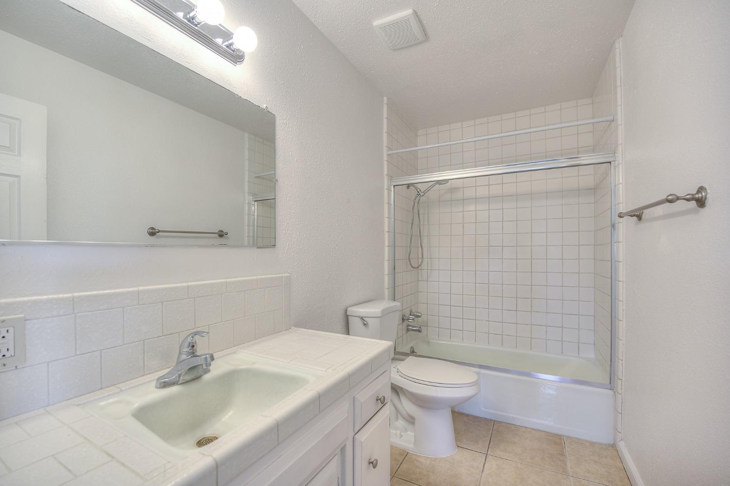 2811 North Winery Avenue Clovis, CA 93612 - Photo 16 of 25 a bathroom with a sink toilet and shower