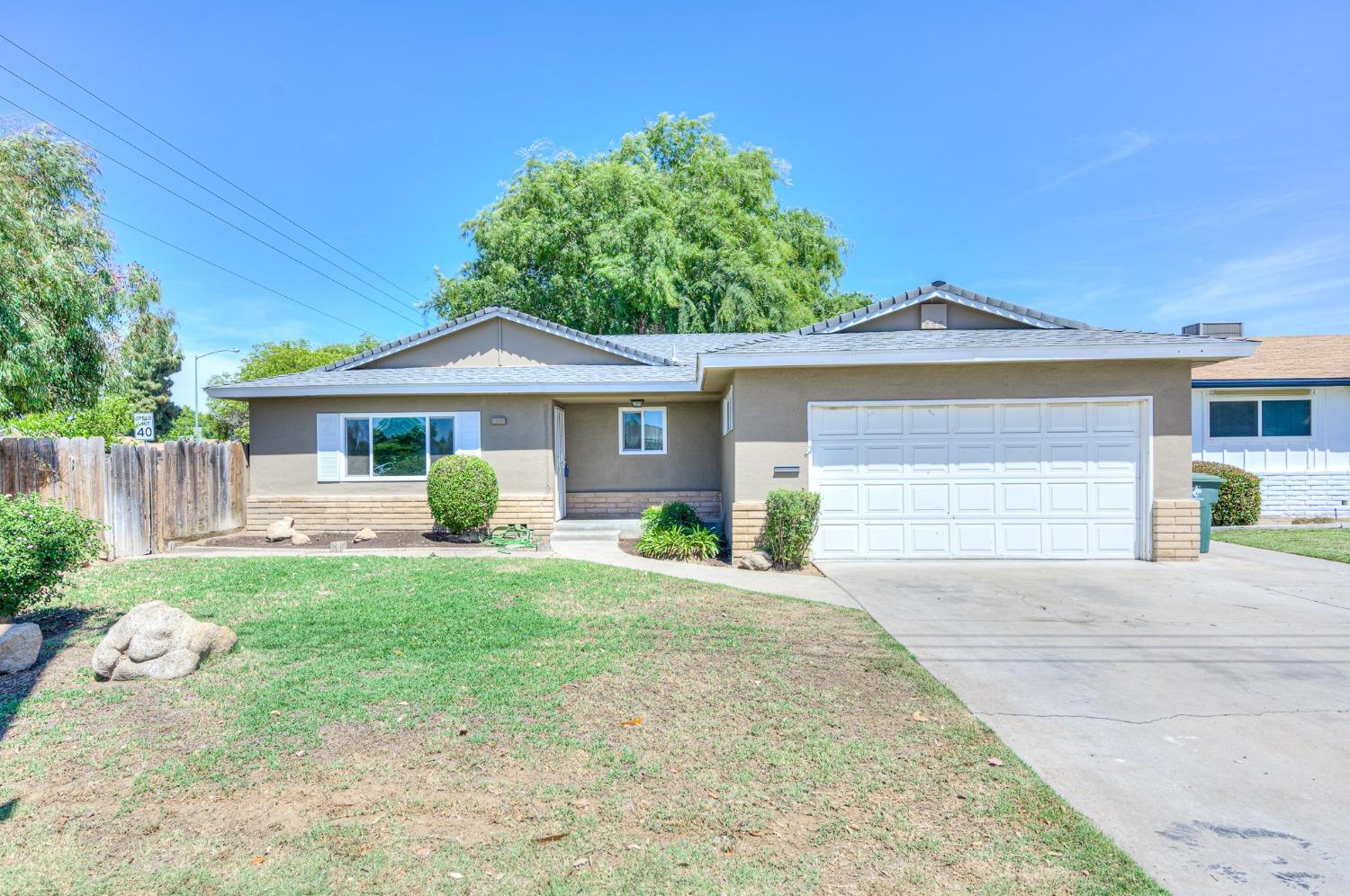 2811 North Winery Avenue Clovis, CA 93612 - Photo 2 of 25 a front view of a house with a yard and porch