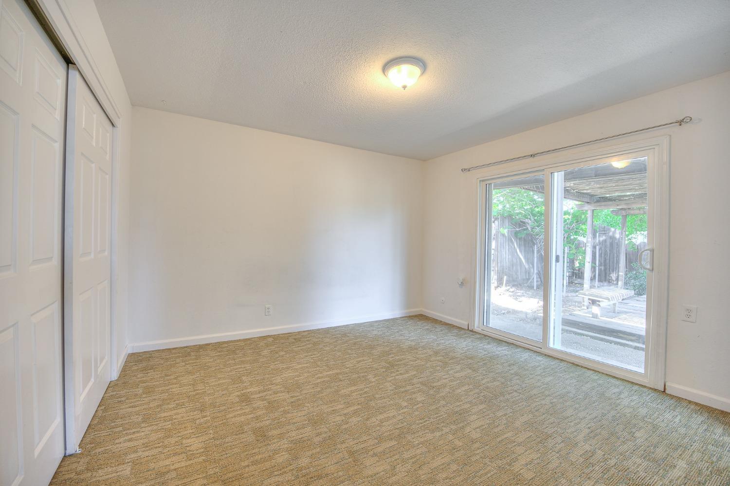 2811 North Winery Avenue Clovis, CA 93612 - Photo 21 of 25 an empty room with wooden floor and windows
