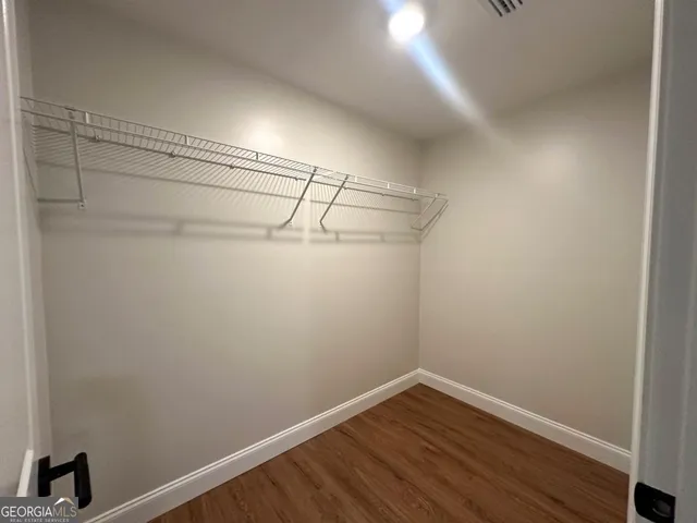 a view of a room with wooden floor