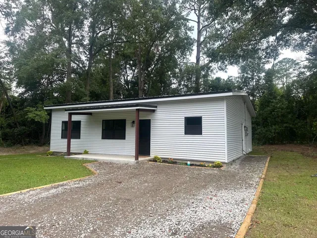a view of a house with a backyard
