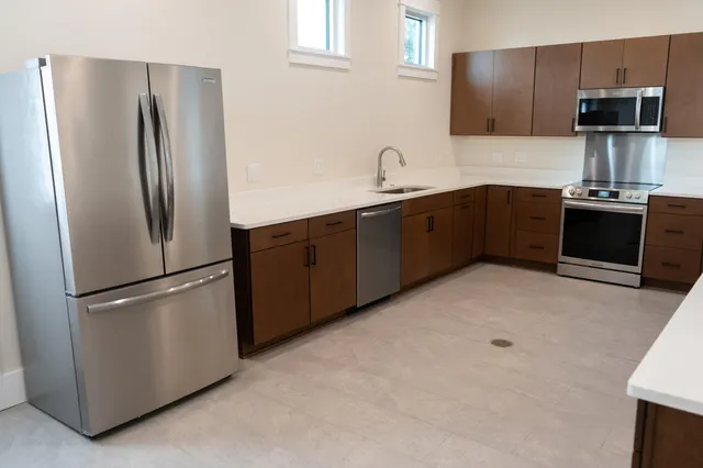 a kitchen with stainless steel appliances a refrigerator and a sink