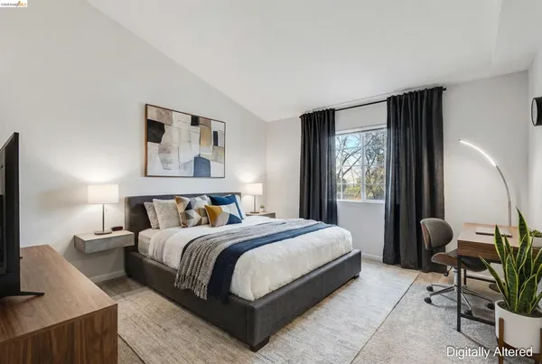 a bedroom with a large bed and a flat screen tv