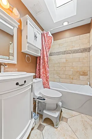 a bathroom with a toilet a sink and bathtub