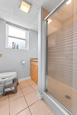 a bathroom with a toilet a sink and shower