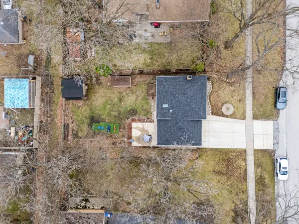 a aerial view of a house with large trees
