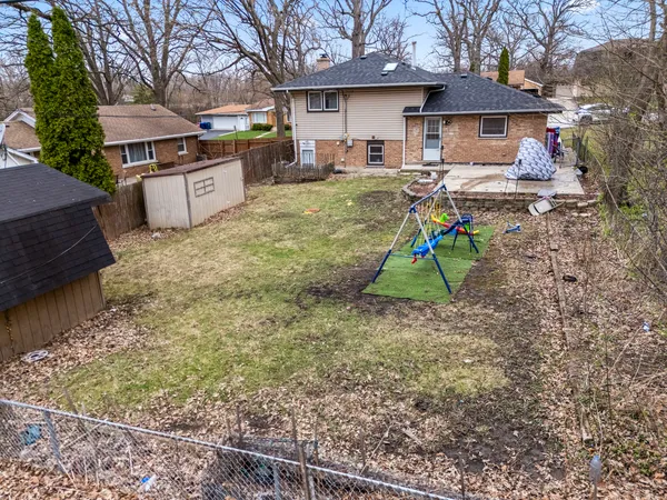 a view of a house with a yard and sitting area