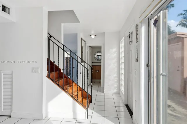 a view of a hallway with wooden floor and door
