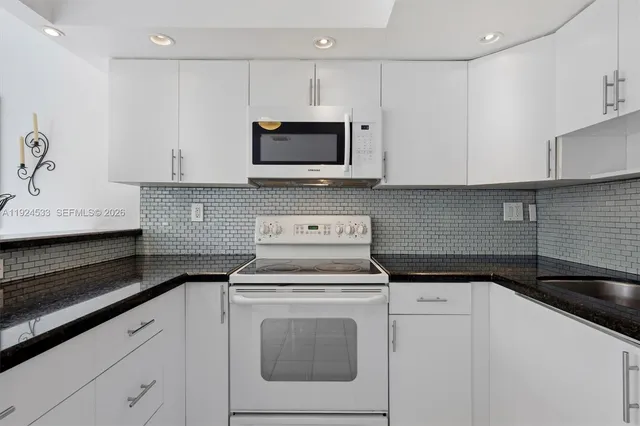 a kitchen with a sink and a washer dryer