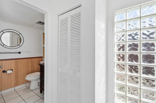 a view of a hallway with wooden floor and entryway