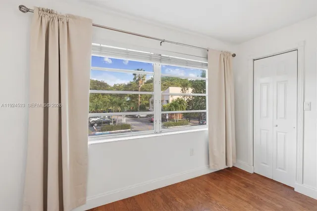 a bathroom with a sink a toilet a mirror and shower