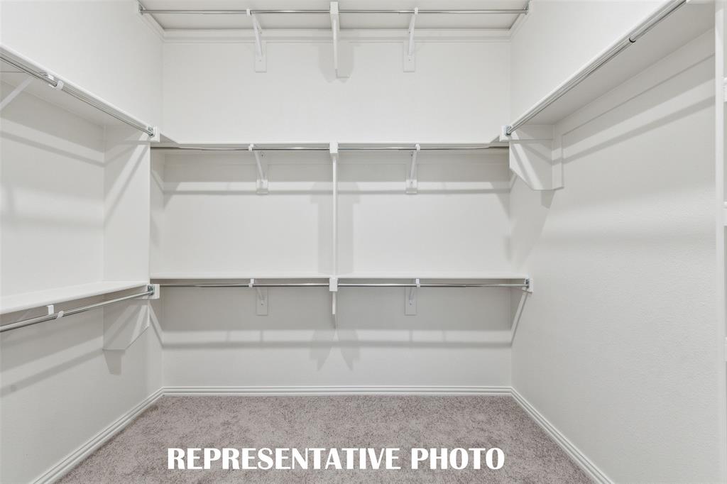 1034 Splitrock Drive Allen, TX 75013 - Photo 11 of 18 a view of walk in closet with empty racks