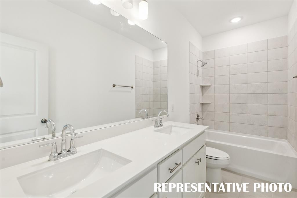 1034 Splitrock Drive Allen, TX 75013 - Photo 15 of 18 a bathroom with a sink a toilet and shower