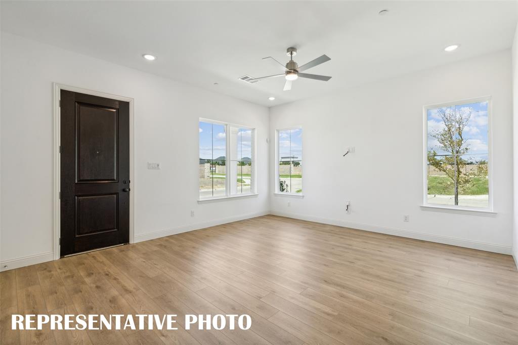 1034 Splitrock Drive Allen, TX 75013 - Photo 3 of 18 a view of an empty room with window and wooden floor