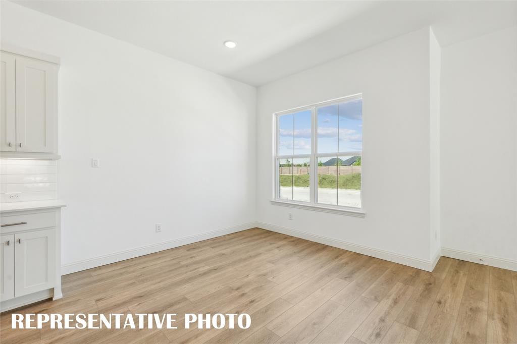 1034 Splitrock Drive Allen, TX 75013 - Photo 4 of 18 an empty room with wooden floor and windows