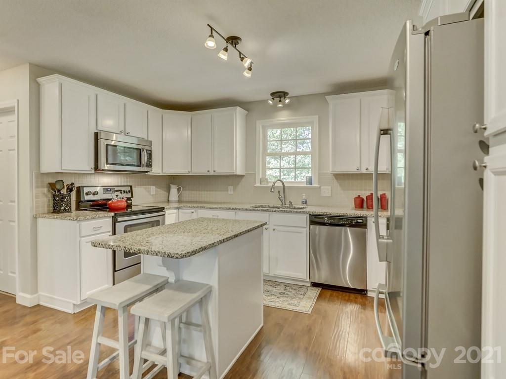 1520 Cobblestone Court Fort Mill, SC 29708 - Photo 11 of 47 a kitchen with stainless steel appliances granite countertop a stove top oven a sink dishwasher and a refrigerator with wooden floor