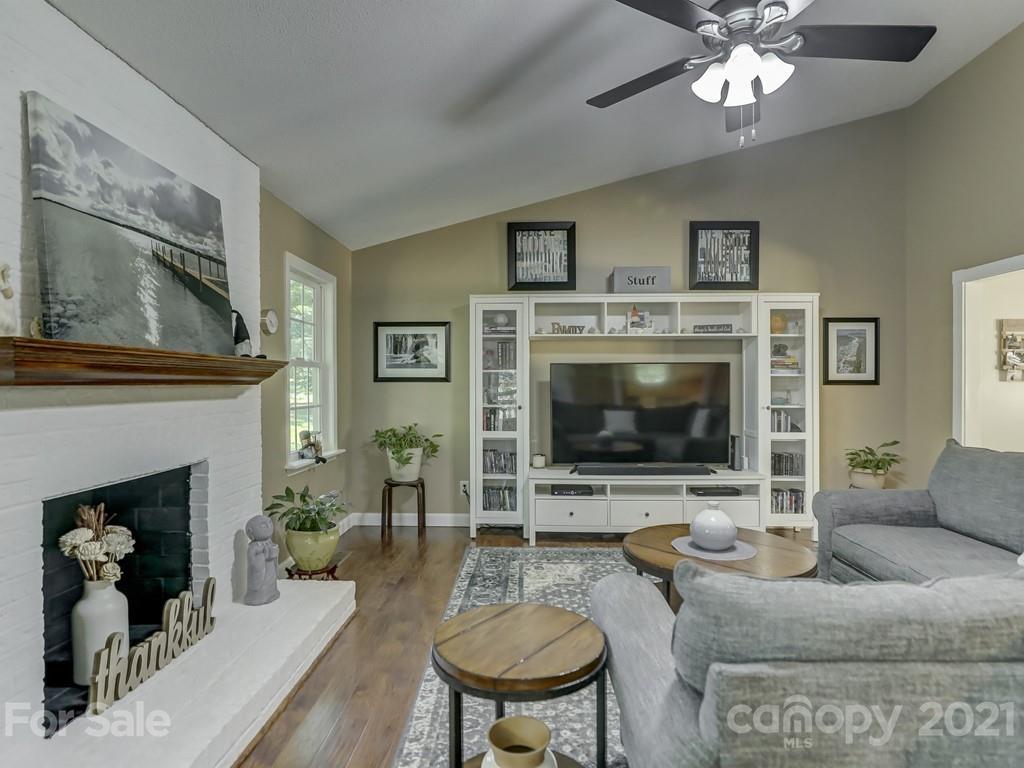 1520 Cobblestone Court Fort Mill, SC 29708 - Photo 16 of 47 a living room with furniture a fireplace and a flat screen tv