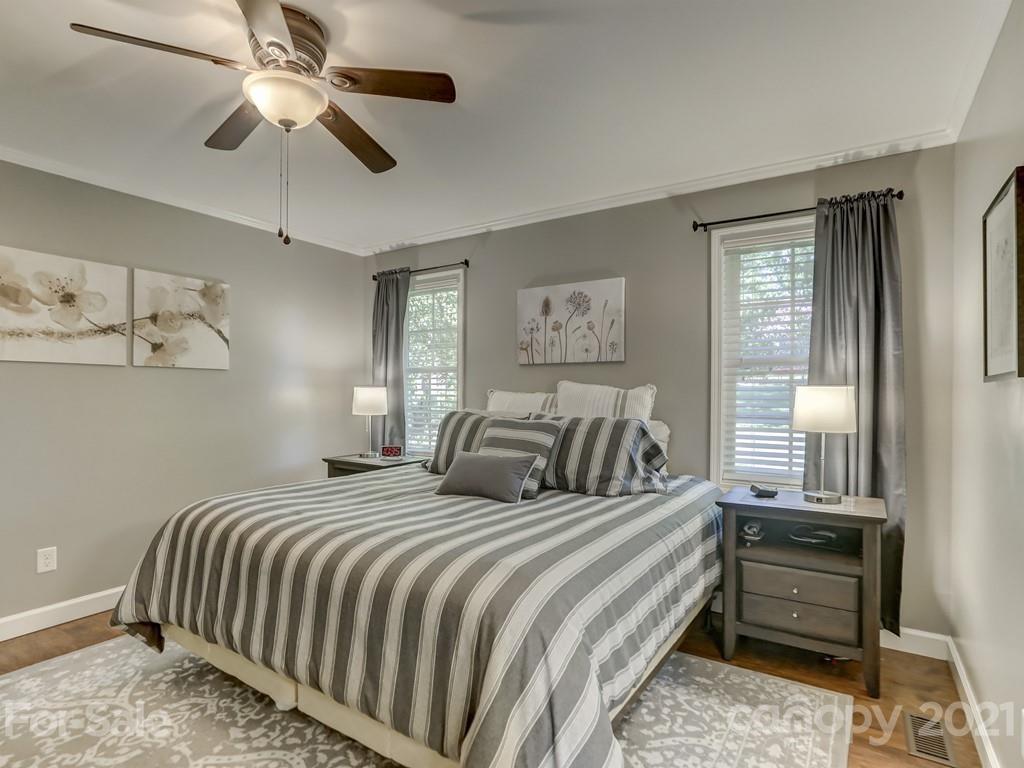 1520 Cobblestone Court Fort Mill, SC 29708 - Photo 19 of 47 a bedroom with a large bed and a chandelier