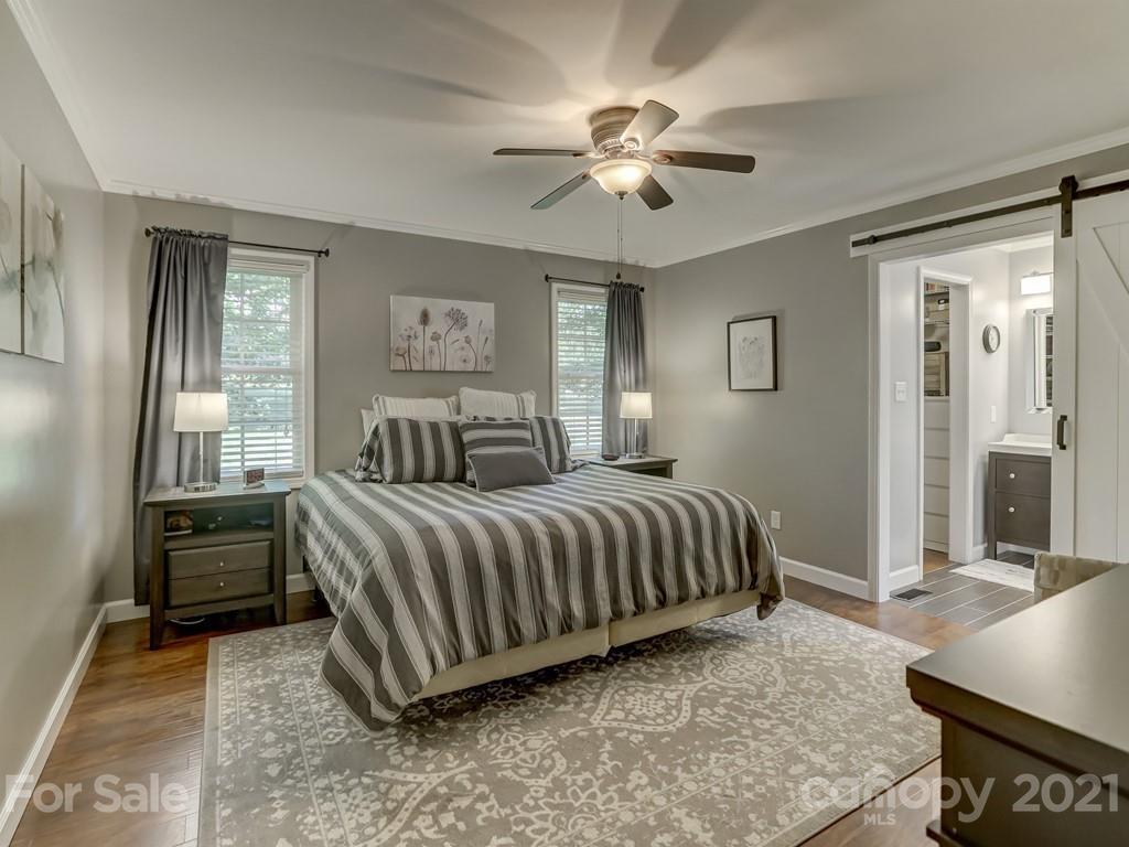 1520 Cobblestone Court Fort Mill, SC 29708 - Photo 20 of 47 a spacious bedroom with a bed and a chandelier