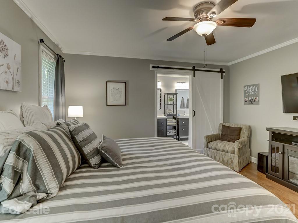 1520 Cobblestone Court Fort Mill, SC 29708 - Photo 21 of 47 a bedroom with a bed and a chandelier