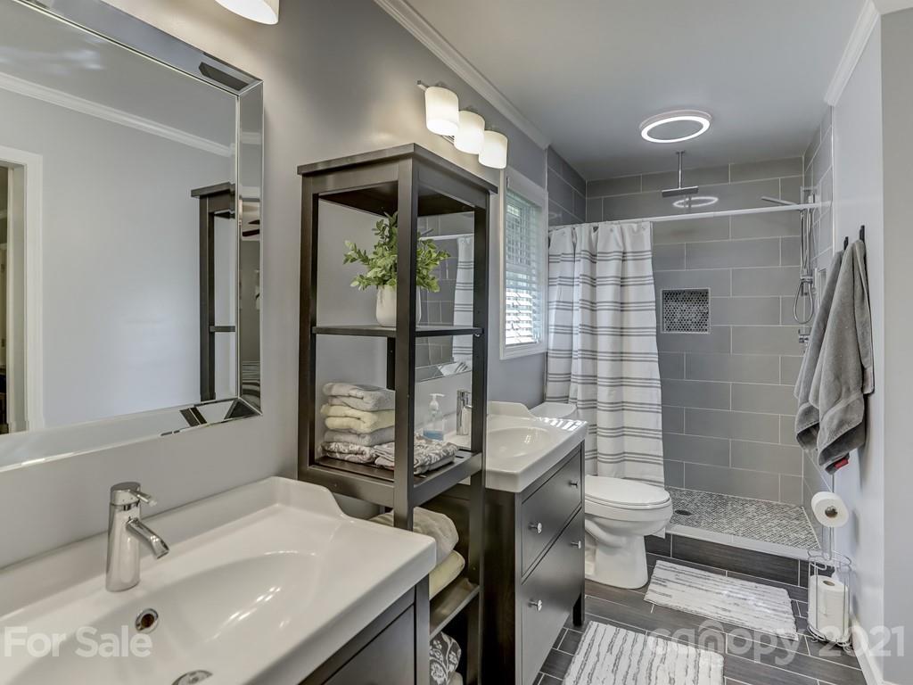 1520 Cobblestone Court Fort Mill, SC 29708 - Photo 24 of 47 a bathroom with a sink a toilet a mirror and shower