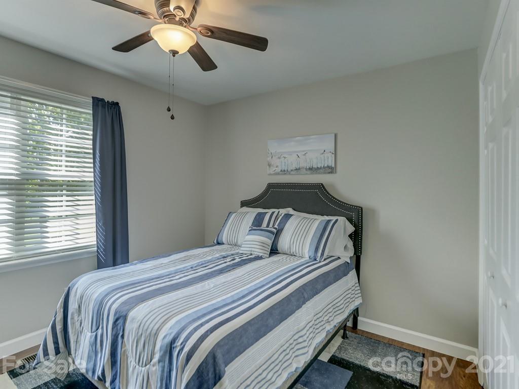 1520 Cobblestone Court Fort Mill, SC 29708 - Photo 26 of 47 a bedroom with a bed and a chandelier