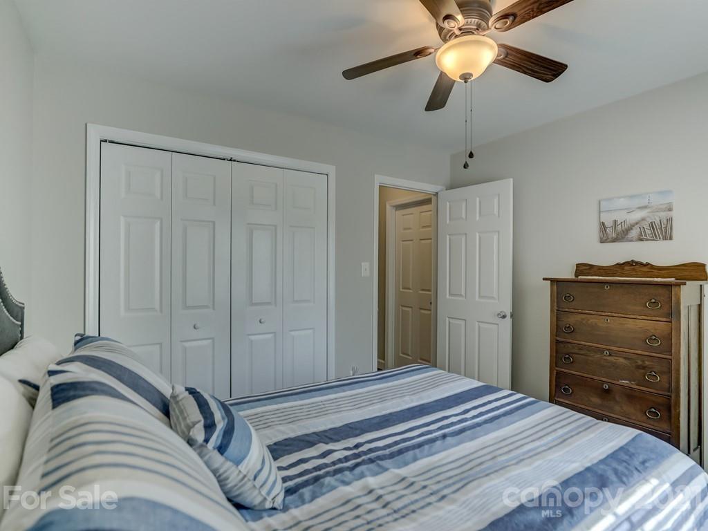 1520 Cobblestone Court Fort Mill, SC 29708 - Photo 28 of 47 a bedroom with a bed and a chandelier
