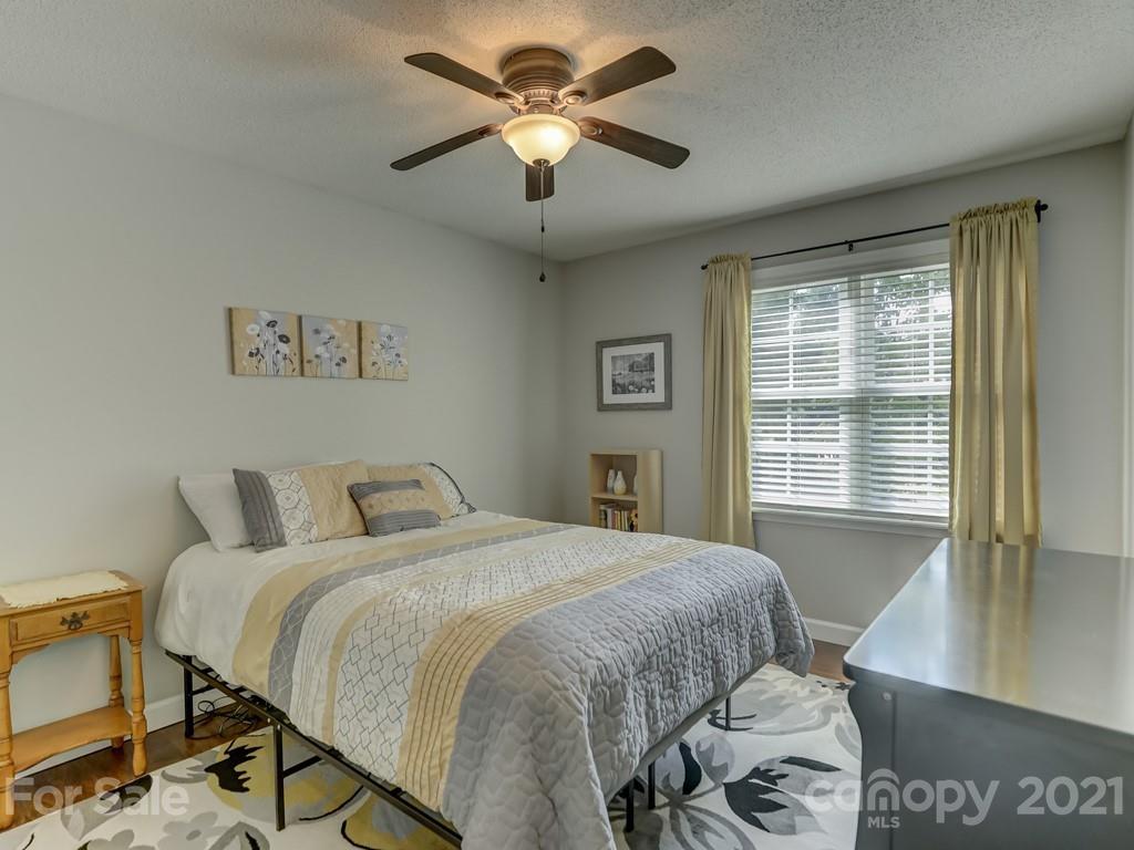 1520 Cobblestone Court Fort Mill, SC 29708 - Photo 31 of 47 a bedroom with a bed and a chandelier