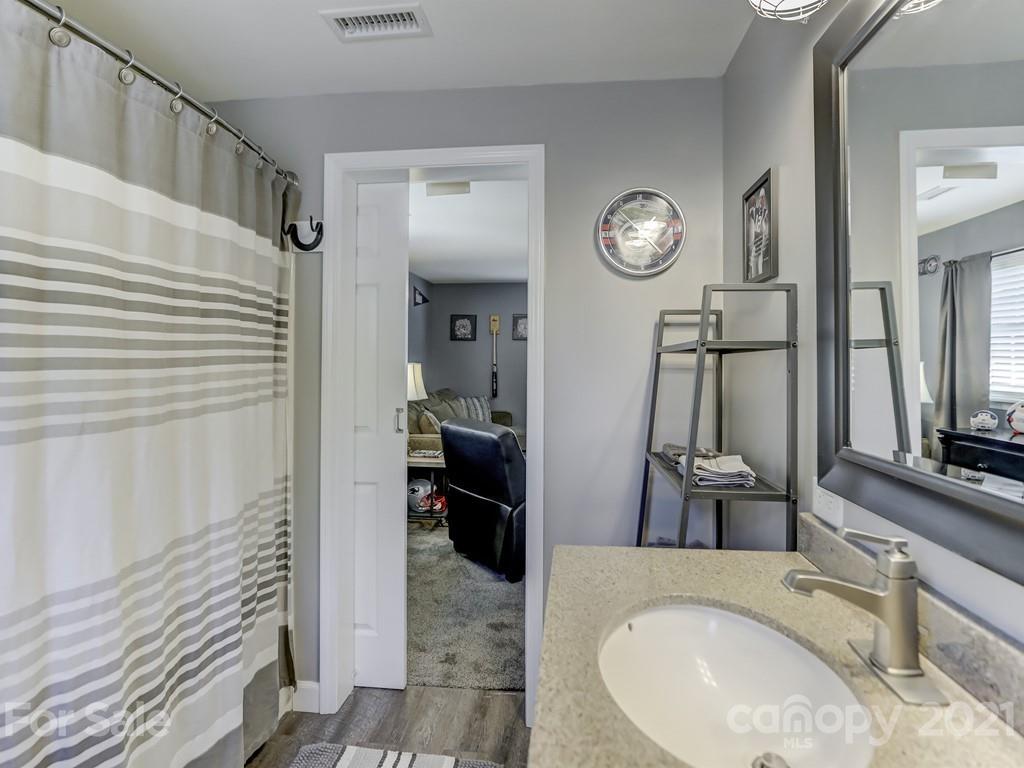 1520 Cobblestone Court Fort Mill, SC 29708 - Photo 33 of 47 a bathroom with a granite countertop sink a mirror and shower