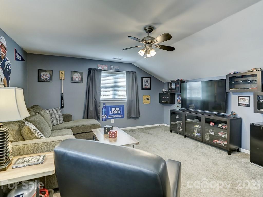 1520 Cobblestone Court Fort Mill, SC 29708 - Photo 36 of 47 a living room with furniture and a flat screen tv